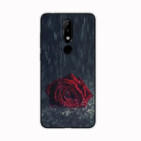 a red rose in the rain on a black background