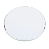 a round mirror with a white background