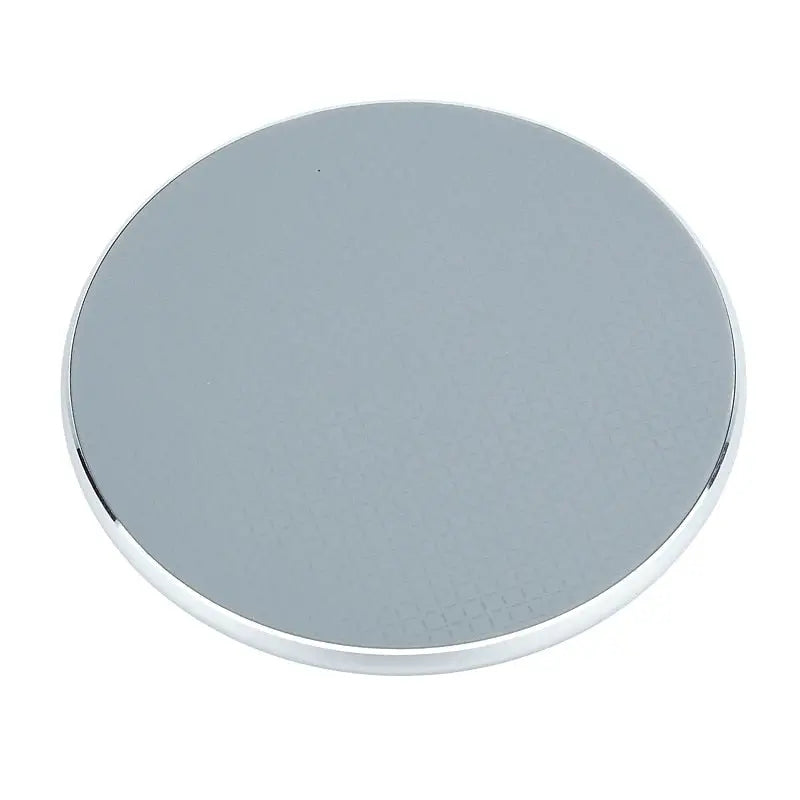 a round mirror with a silver surface