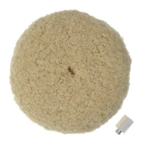 a white wool ball with a small metal button