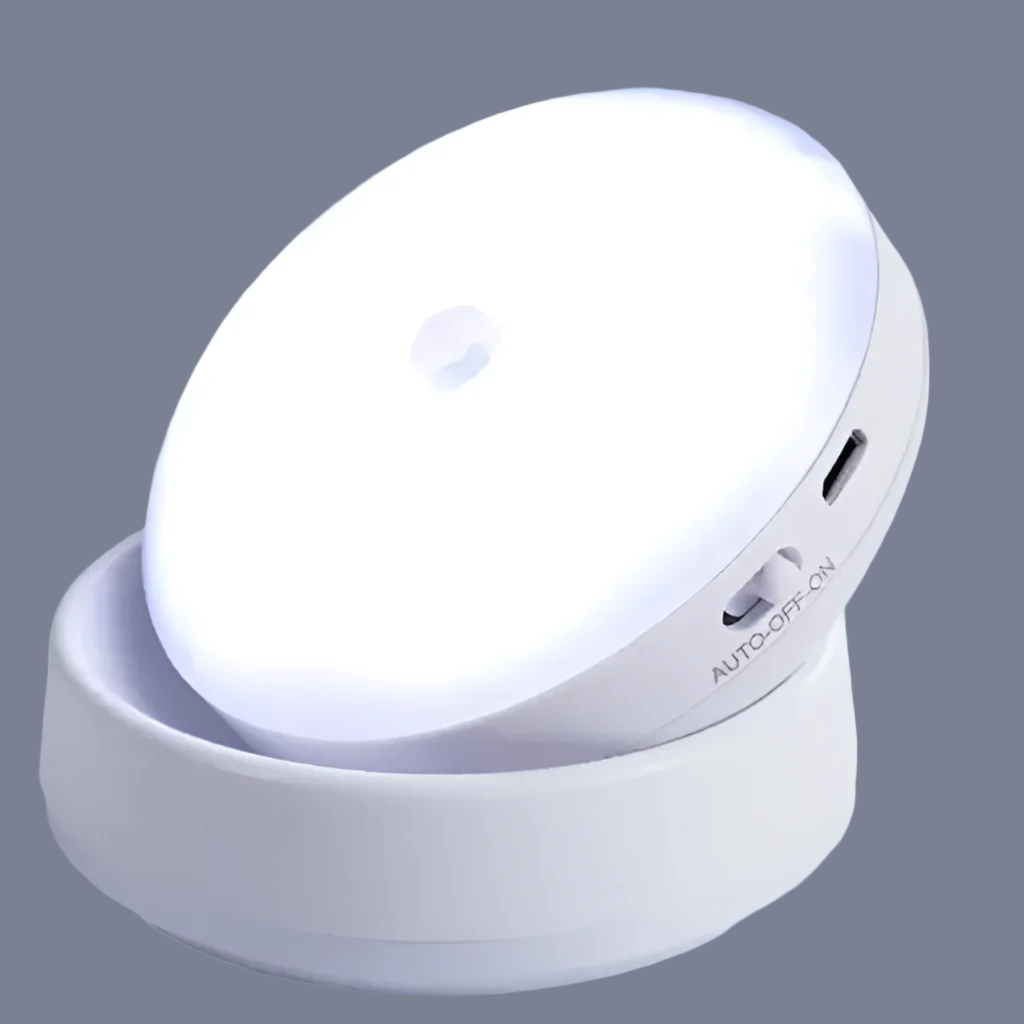 Rounded white electronic device with a circular light panel sitting on a base.