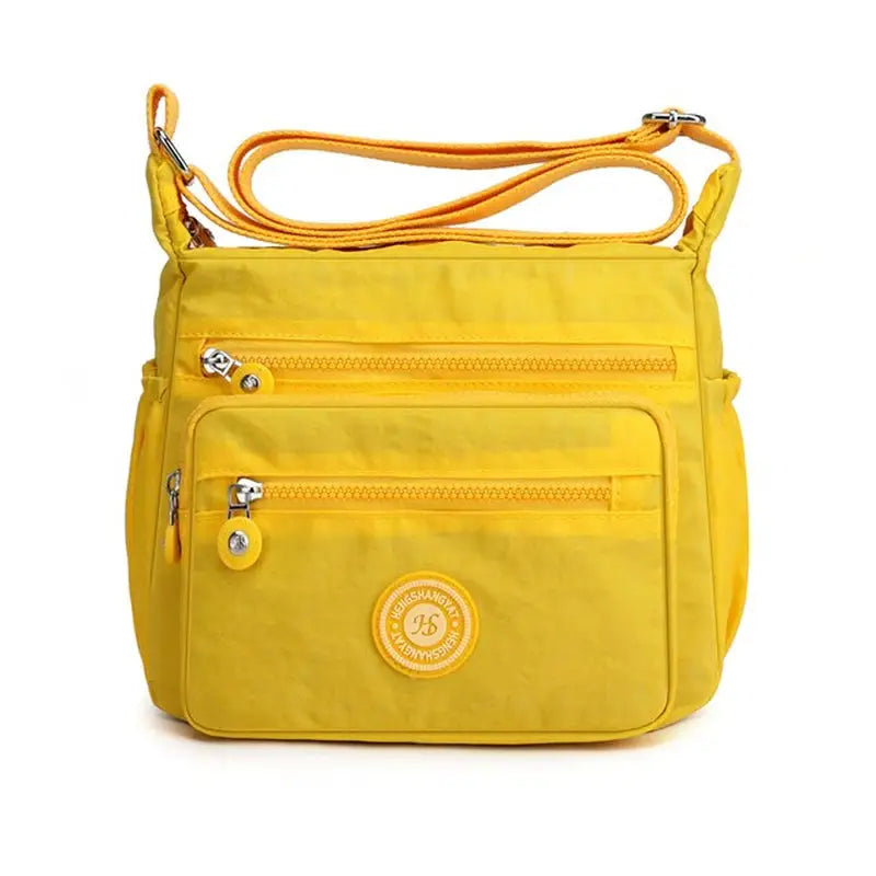 yellow purse with a strap and a zipper on the front