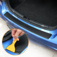 a person cleaning a car with a sponge