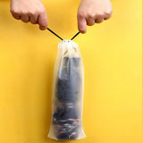 a person holding a plastic bag with a black handle