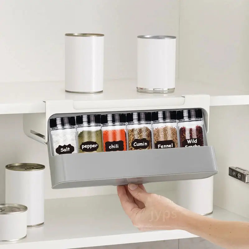 a person holding a spice rack with spices