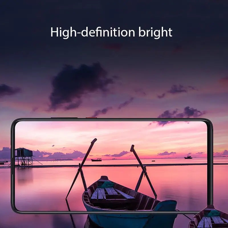 a close up of a boat on a body of water with a sunset in the background