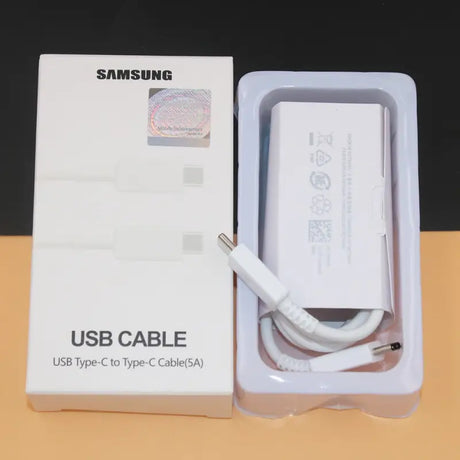 a close up of a box with a charger and a cable