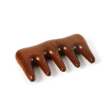 a wooden hair clip with three claws