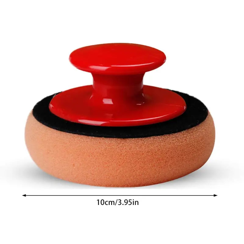 a red and black sander with a red knob