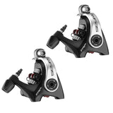 two black and silver fishing reels with a white background