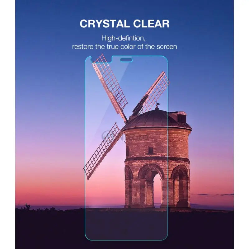 a close up of a cell phone with a windmill in the background