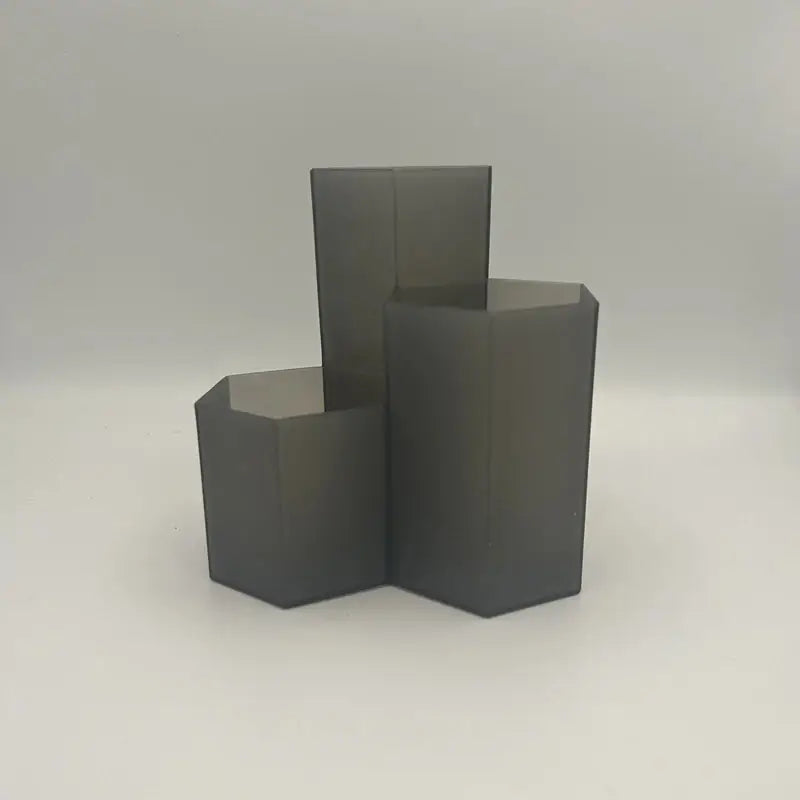 three black cubes on a white surface