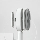 the hair brush is on a white stand