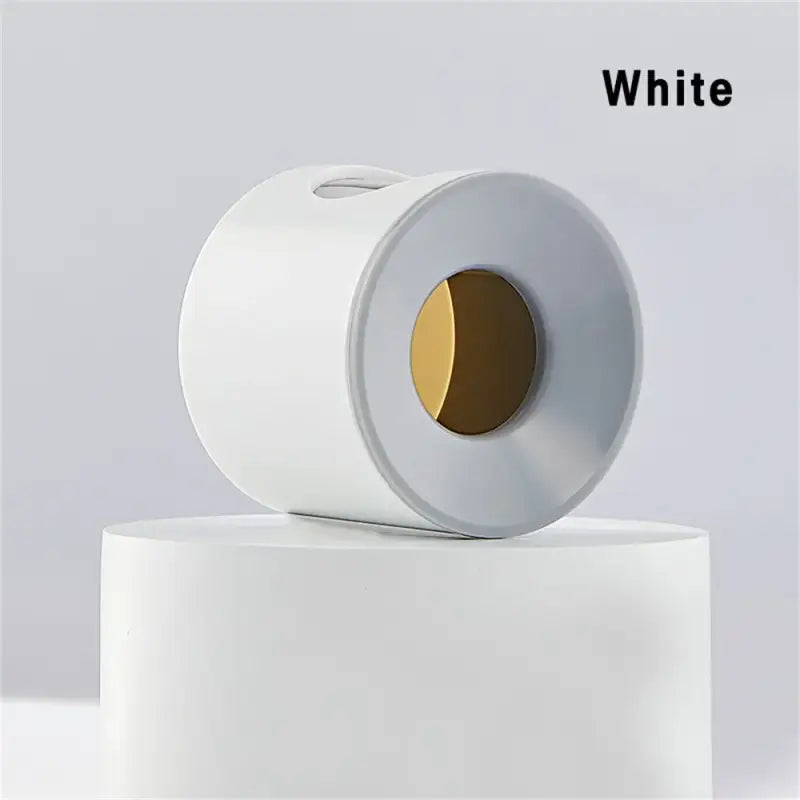 a roll of toilet paper on a white pedestal