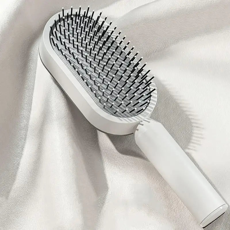 a hair brush on a white cloth