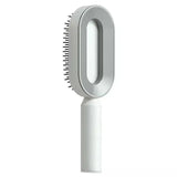 a white brush with a handle on a white background