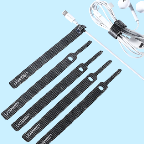 Set of black cable ties or straps with a white charging cable visible.