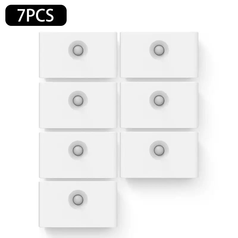 a set of five white square knobs with a round knob