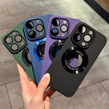 A set of four colorful smartphone cases with camera cutouts and a circular magnetic accessory.