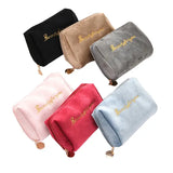 a set of four velvet makeup bags