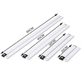 A set of four white plastic door handles with black handles