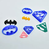 a set of superhero cookie cutters with different shapes
