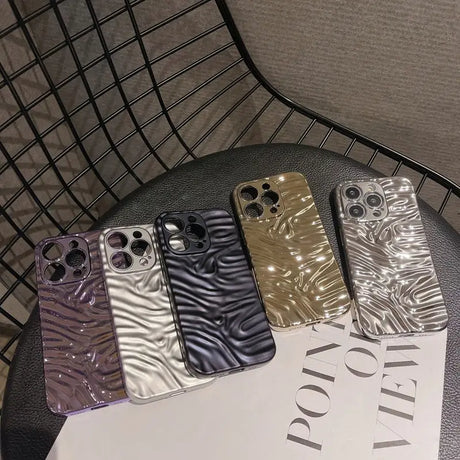 A set of three iphone cases sitting on a table