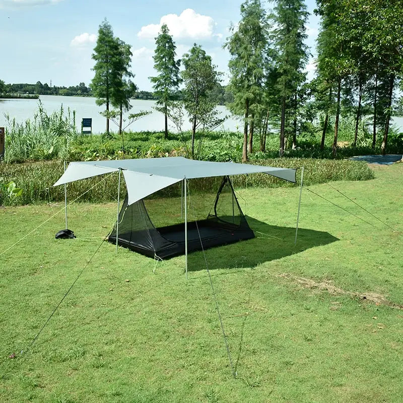 a tent is set up on the grass