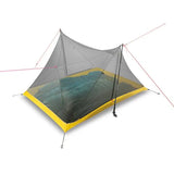 a close up of a tent with a net on the ground