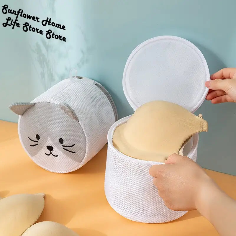 a person putting a piece of paper into a cat shaped container