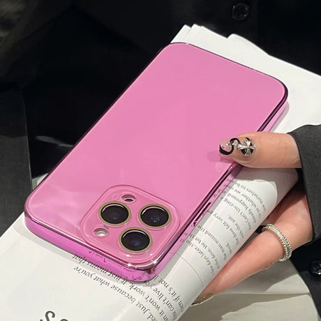 A shiny pink phone case with a transparent camera cutout.