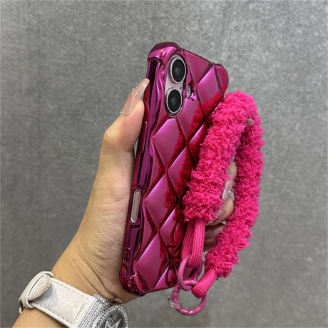 Shiny pink quilted phone case with fuzzy strap.