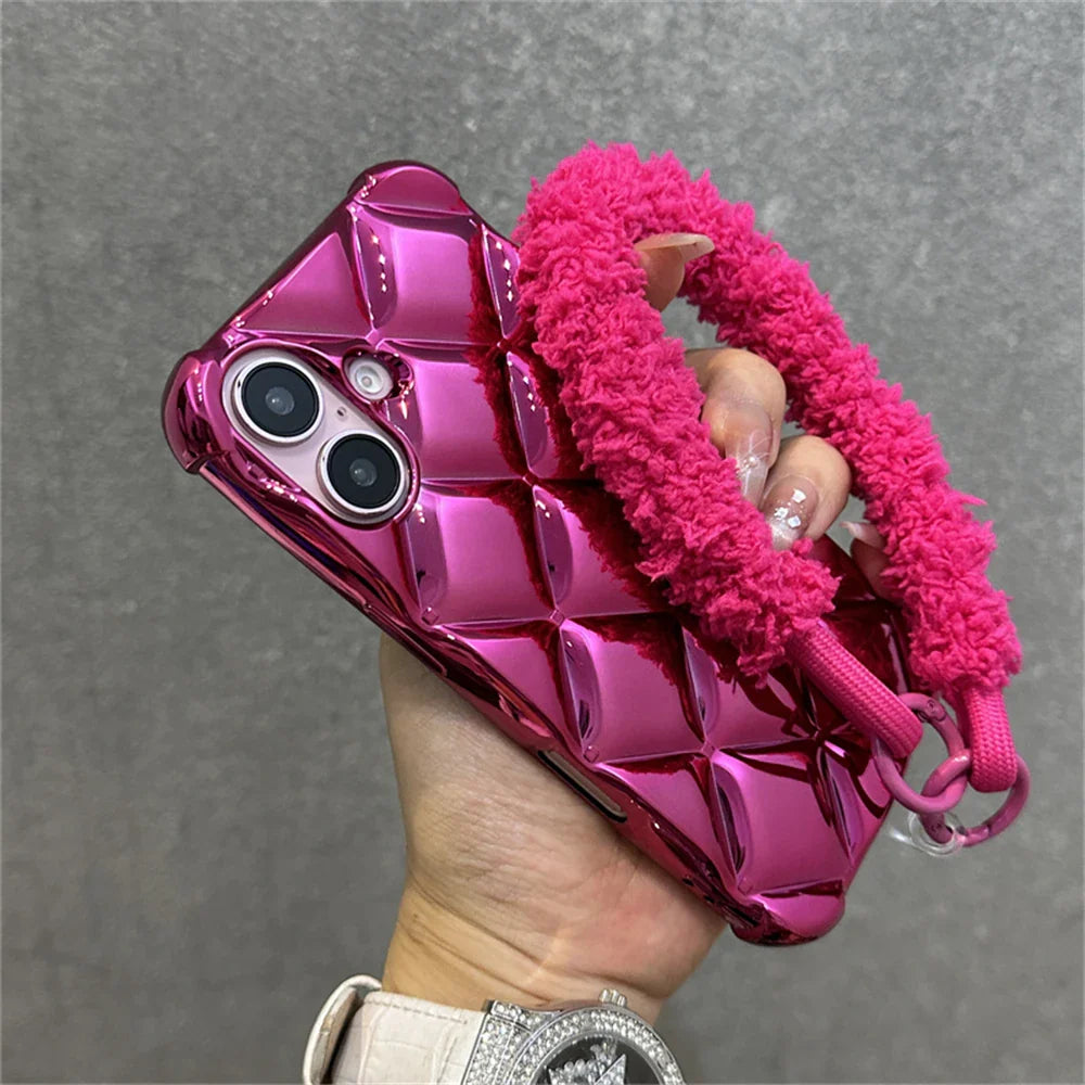 Shiny pink quilted phone case with fuzzy strap.