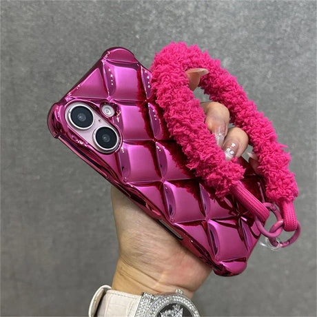 Shiny pink quilted phone case with fuzzy strap.