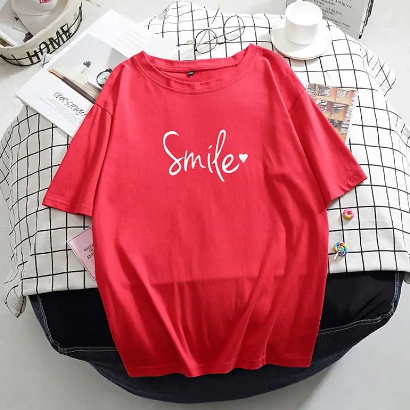 a red shirt with the word smile on it
