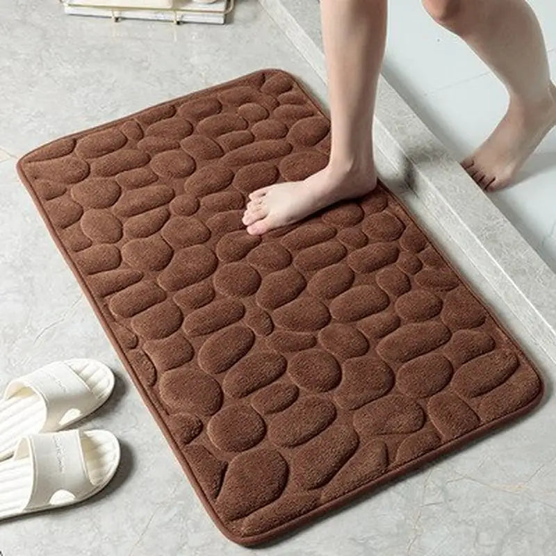 a person standing on a bathroom mat