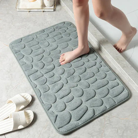 a woman is standing on the floor with her feet on the bathroom mat