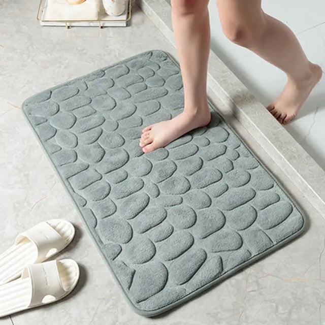 a woman is standing on the floor with her feet on the bathroom mat