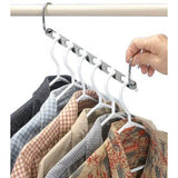 a person holding a coat rack with clothes hanging on it