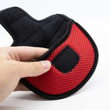 a hand holding a red and black glove