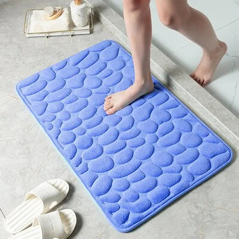 a woman is standing on a blue bath mat
