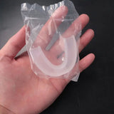 a hand holding a clear plastic bag with a white plastic handle