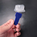 a hand holding a plastic bottle with a plastic cap