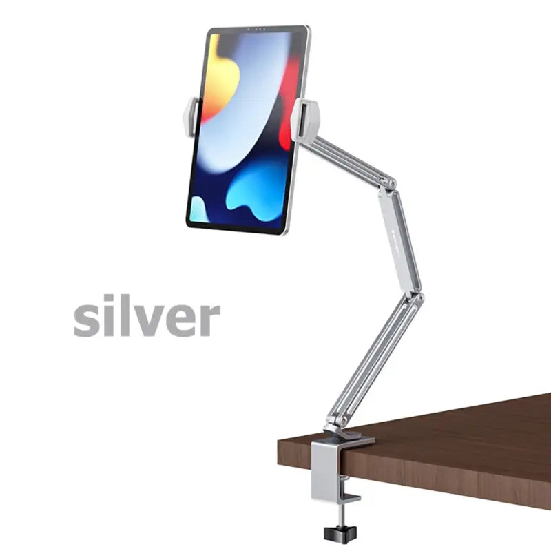 the silver desk lamp is on top of a wooden table