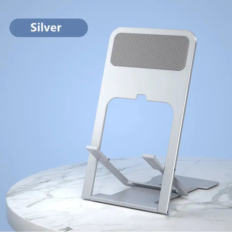 a silver phone stand on a marble table