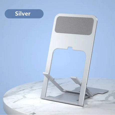 a silver phone stand on a marble table