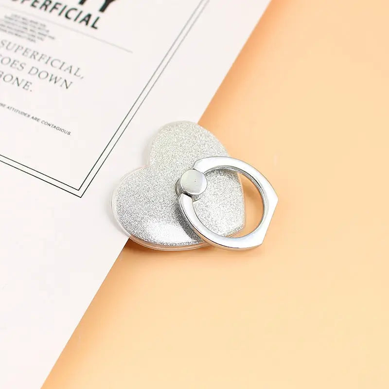 a heart shaped ring on top of a book
