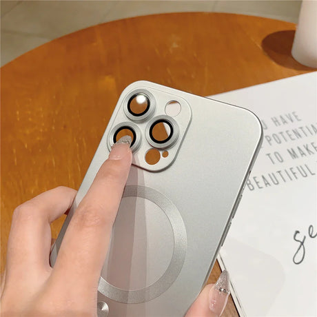 Silver iPhone with camera lens protectors.