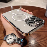 someone holding a silver ipod with a watch on it