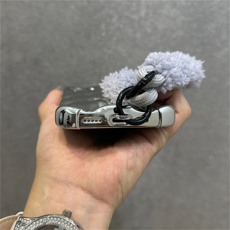 Silver phone case with fluffy strap.